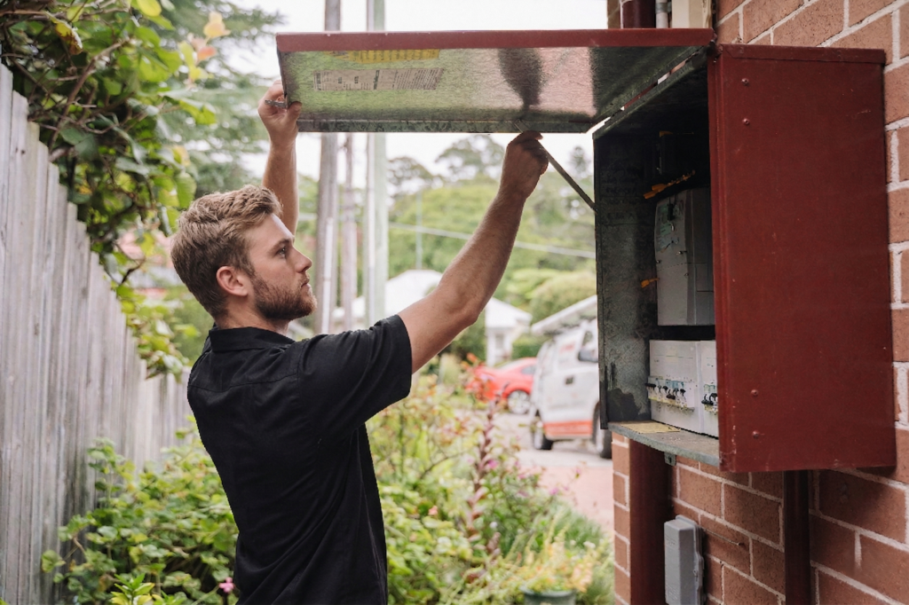 Electrician installing downlights in a Dulwich Hill home
